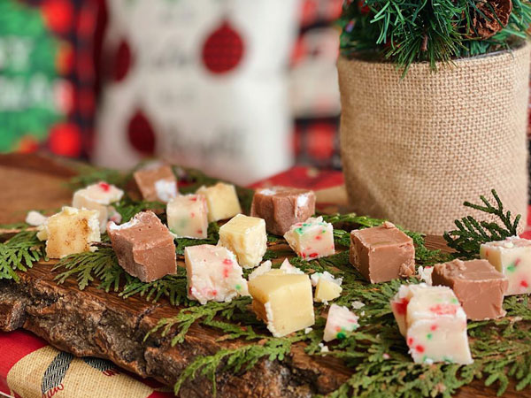 Christmas Fudge Flavours on a wooden tray with xmas decoration in the background