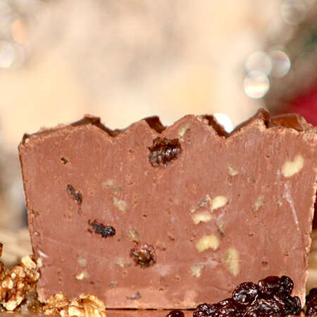 Candy Cane Fudge with a coffee mug and candy canes. A christmas tree in the background.