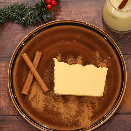 Egg not fudge on a plate with cinnamon sticks and egg nog